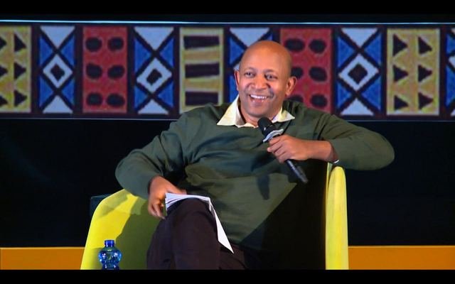 Dr Mehret Debebe seated on stage
