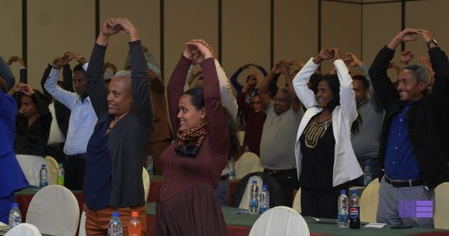 Participants with arms raised